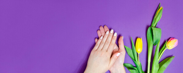 Female manicure on a bright background. Purple
