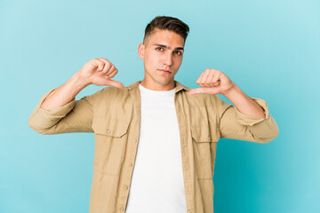 Young caucasian handsome man isolated feels proud and self confident, example to follow.