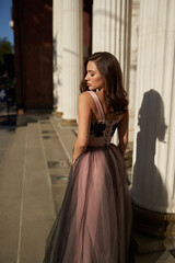 Young beautiful woman in an evening dress in the theater