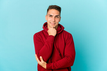 Young caucasian handsome man isolated smiling happy and confident, touching chin with hand.