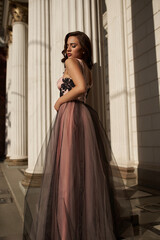 Fototapeta premium Young beautiful woman in an evening dress in the theater