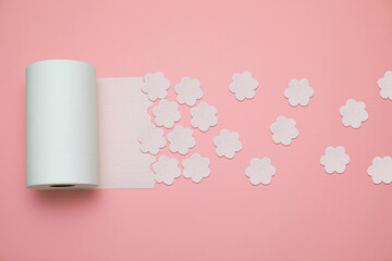 Toilet paper unrolling and leaving soft flower shape in trace. Conceptual pattern background