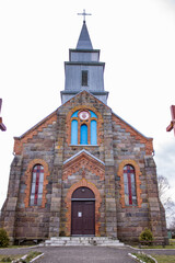 An old stone church behind an iron fence