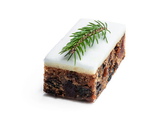 Fruit cake slice topped with marzipan isolated on white