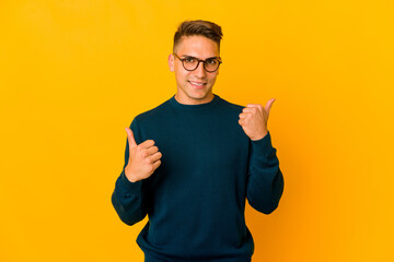 Young handsome caucasian man isolated raising both thumbs up, smiling and confident.