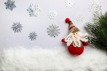 Happy holiday toy santa claus standing in winter christmas background. Christmas concept. Flat lay, top view.
