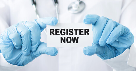 Register now text on the card in the hands of the doctor. Medical concept