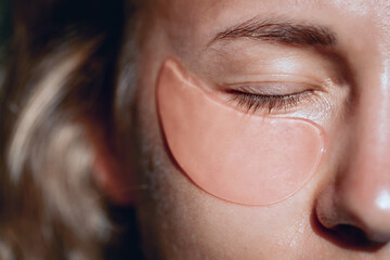 Cute young lady without any make up with a patches under her eyes, close up