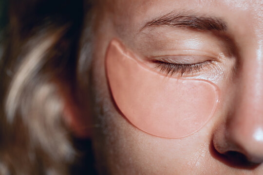 Cute young lady without any make up with a patches under her eyes, close up