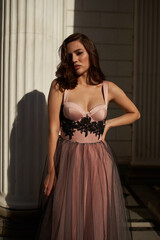 Young beautiful woman in an evening dress in the theater