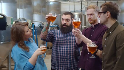 Young hipster people tasting fresh beer in modern brewery