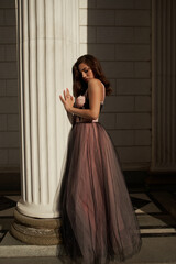 Fototapeta premium Young beautiful woman in an evening dress in the theater