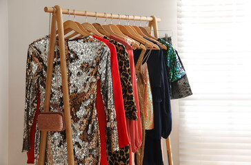 Rack with stylish women's clothes indoors. Interior design
