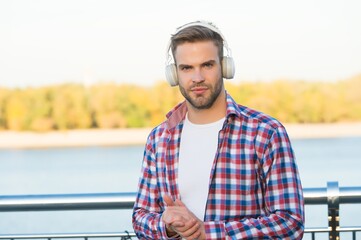 elearning concept. quality of sound. innovative wireless device. unshaven guy with ear stereo...