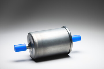 New fuel filter for gasoline internal combustion engine with blue caps on a gray background. New...