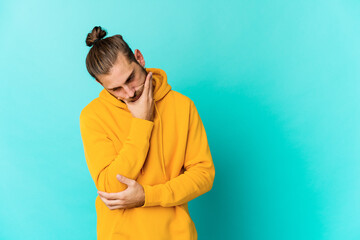 Young man with long hair look tired of a repetitive task.