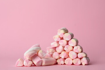 Stack of tasty marshmallows on pink background