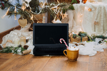 Naklejka na ściany i meble Virtual Christmas party, xmas parties moving online in new normal, social distance, stay home reality. Laptop near fir tree ready for Christmas online holiday remote celebration, meeting.