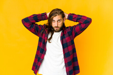 Young man with long hair look screaming, very excited, passionate, satisfied with something.