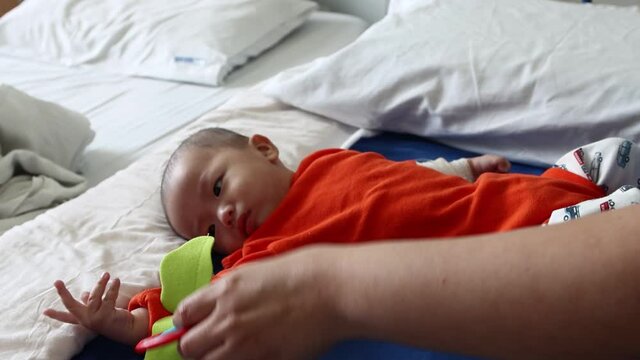 Little baby boy resting on hospital wad bed