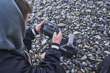 Quadcopter videography. young man holds a control panel with monitor in his hand, hobby to shoot video