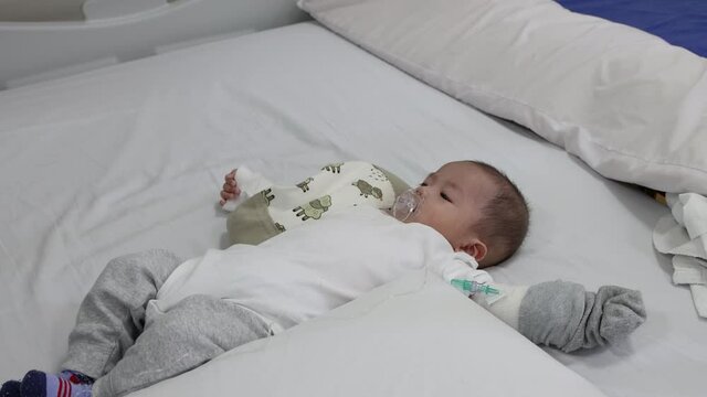 Little baby boy resting on hospital wad bed