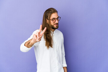 Young man with long hair look showing victory sign and smiling broadly.