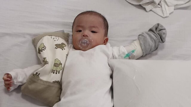 Little baby boy resting on hospital wad bed