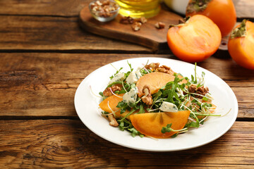Delicious persimmon salad served on wooden table