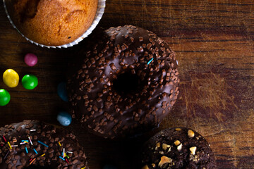 Donuts on a wooden board on a blue concrete background