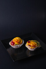 Cheese dessert with orange on a black background