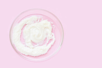 Collagen white powder. Pastel color background. Health product. Woman cosmetics concept. Sport supplement. Skincare cosmetics. Pink monochrome