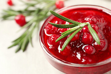 Cranberry sauce with rosemary in bowl, closeup. Space for text