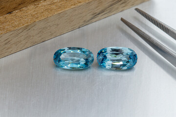 macro mineral faceted stone cut aquamarine on a gray background