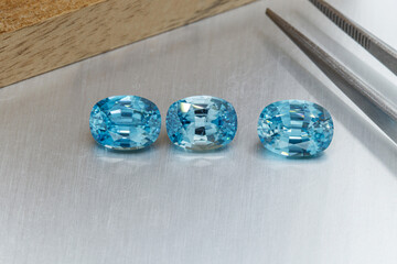 macro mineral faceted stone cut aquamarine on a gray background