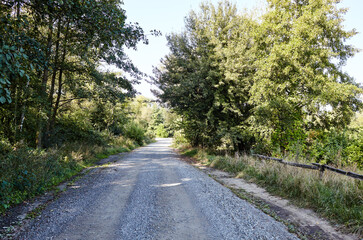 Fototapeta na wymiar A gravel road at rural Europe