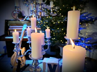 Christmas mood with lighted candles and musical instruments