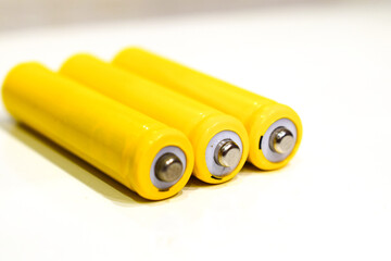 Multiple AAA batteries. Yellow color of the wrapper.