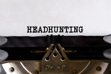 Vintage typewriter with typed text - HEADHUNTING, on a sheet of paper