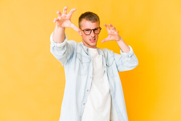 Young caucasian handsome man upset screaming with tense hands.