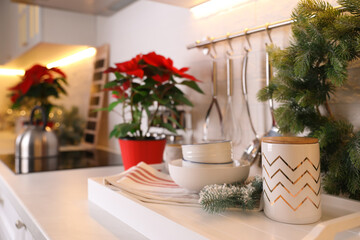 Set of kitchenware and Christmas decor on countertop indoors