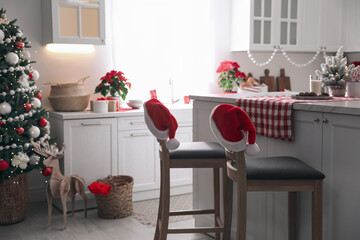 Beautiful kitchen interior with Christmas tree and festive decor