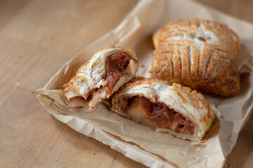 Half eaten apple turnover on paper bag