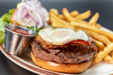 Fresh off the grill fried egg, bacon, and hamburger served with all the familiar french fries and veggie sides.