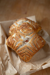 Fresh baked apple turnover on a paper bag