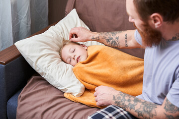 Father touching head and straightens hair of his sick unhealthy daughter