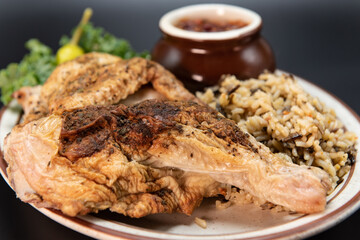 Fresh off the grill half roasted chicken served with all the familiar baked potato and rice sides.