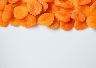 Dry apricots placed on a white board. Place for text 