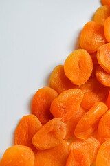 Dry apricots placed on a white board. Place for text 