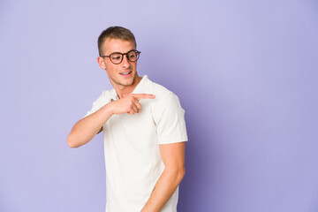 Young caucasian handsome man looks aside smiling, cheerful and pleasant.
